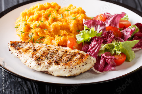 Healthy food: grilled chicken fillet with mashed potatoes and fresh salad closeup on a plate. horizontal