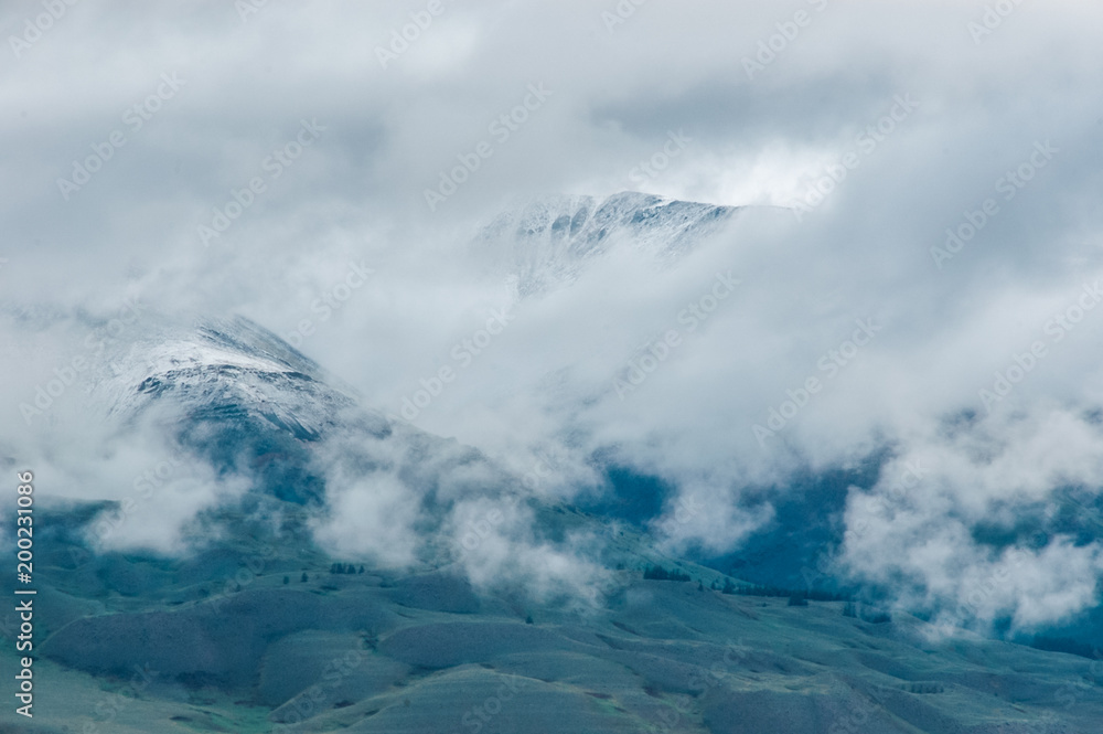 Mountain landscape with clouds. Mountain valley. The Altai mountains. Travel adventure vacation background