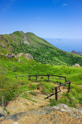 Alpine landscape with stairs descending towards the Mediteranean Sea in Beigua National Geopark, Liguria, Italy