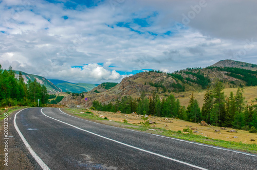 Mountain landscape with clouds. Mountain valley road. The Altai mountains. Travel adventure vacation background