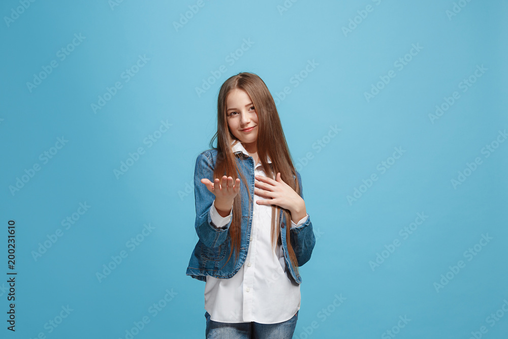 The happy teen girl with phone standing and smiling against pink background. The happy teen girl with phone standing and smiling against pink background.
