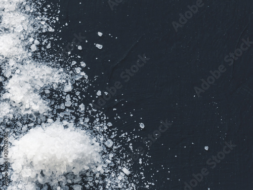 White salt on black background