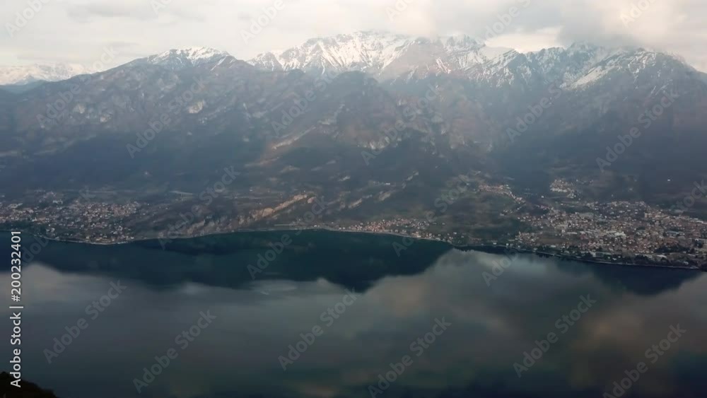 Drone flying over Magreglio, Lake Como, Italy. Aerial view of charming Italian village seen from the sky, with the Alps in the background Drone flying over Magreglio, Lake Como, Italy. Aerial view of charming Italian village seen from the sky, with the Alps in the background