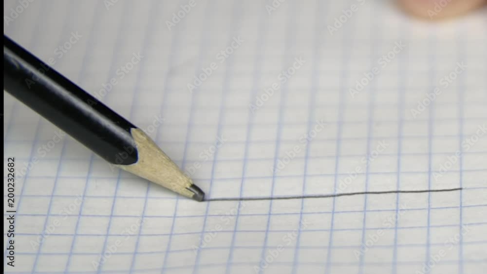 Drawing one line on copybook page with pencil Drawing one line on copybook page with pencil