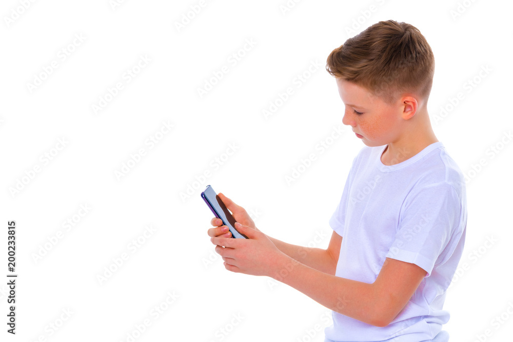 A little boy uses a mobile phone. A little boy uses a mobile phone.
