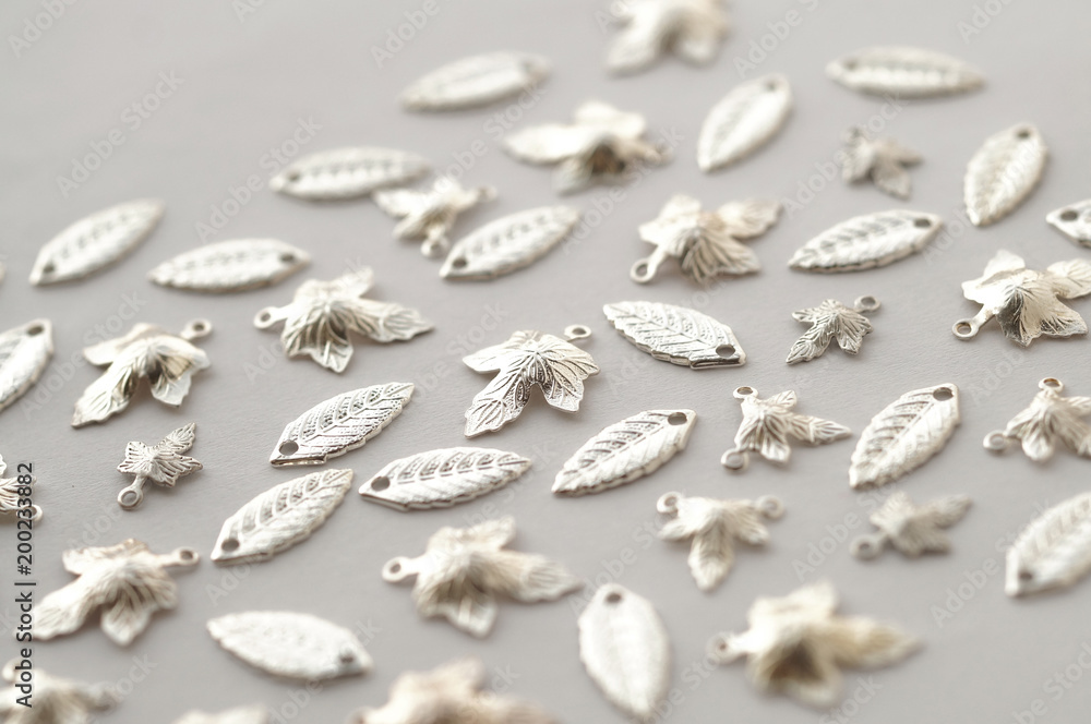 Plenty of silver shining metal leaves. Jewelry findings