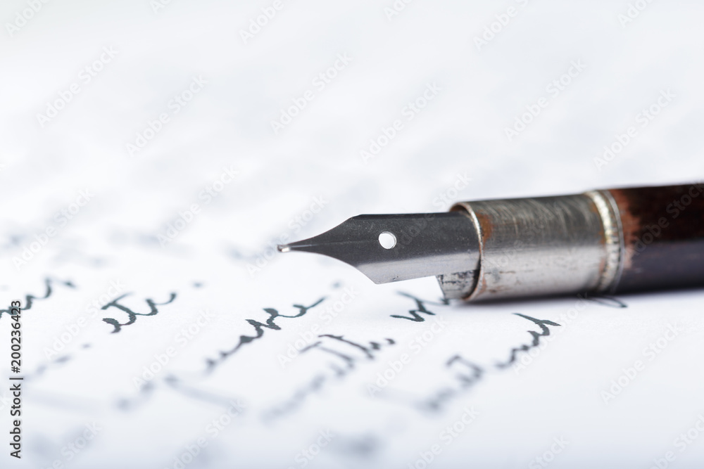 Fountain pen on an antique handwritten letter