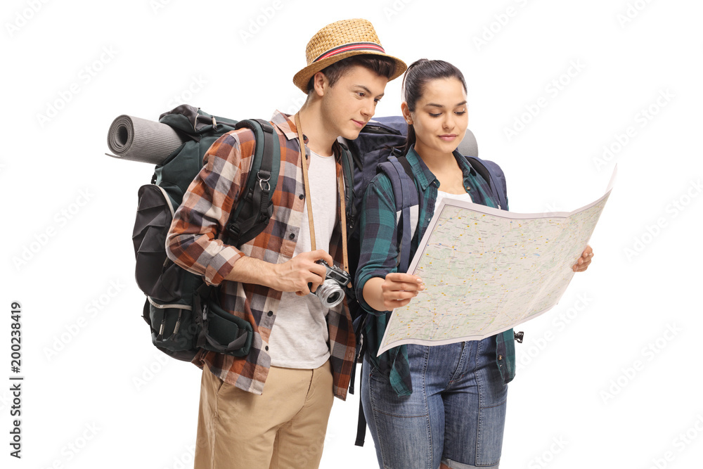 Teenage tourists looking at a map - obrazy, fototapety, plakaty 