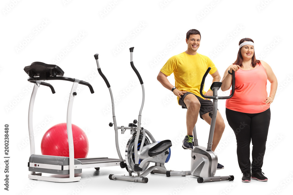 Young man and an overweight woman with exercise machines Young man and an overweight woman with exercise machines