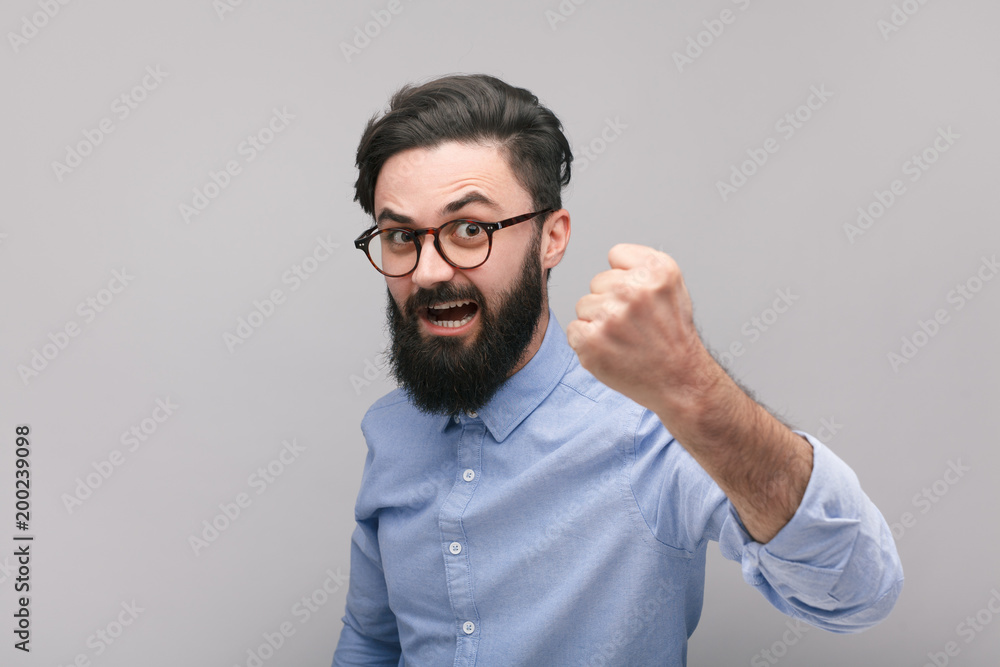 Bearded man showing fist Bearded man showing fist