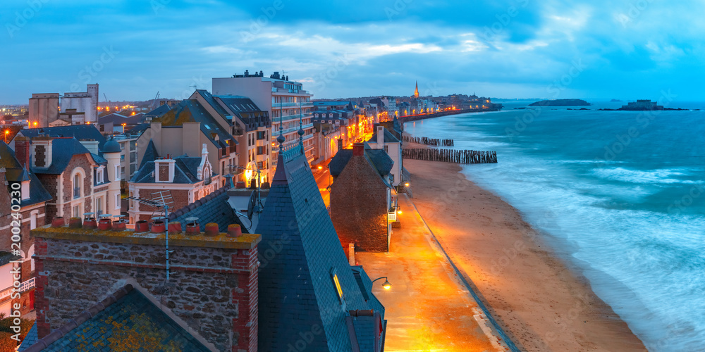 Panoramic aerial night view of beautiful walled port city of Privateers Saint-Malo is known as city corsaire at high tide, Brittany, France - obrazy, fototapety, plakaty 