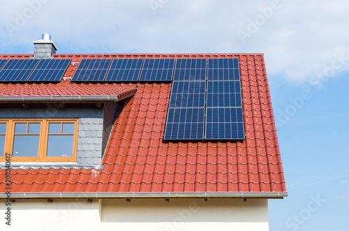 red tiled roof with photovoltaic or solar panels 