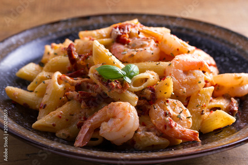 Shrimp pasta with sun dried tomatoes and basil in creamy mozzarella sauce
