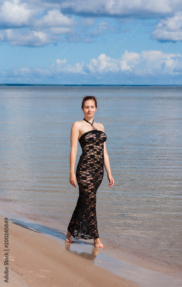 Fototapeta premium Young elegant woman in black lace dress