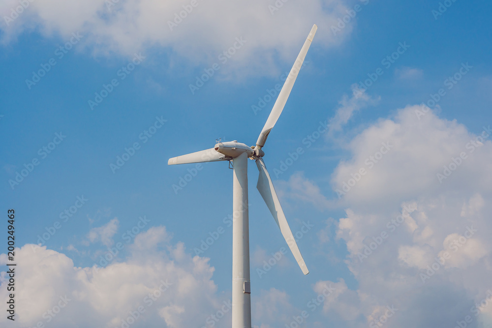 Windmill against cloudy sky with copyspace Windmill against cloudy sky with copyspace