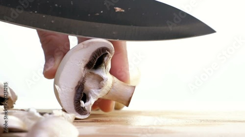 Cut champignons on a wooden board. white background photo