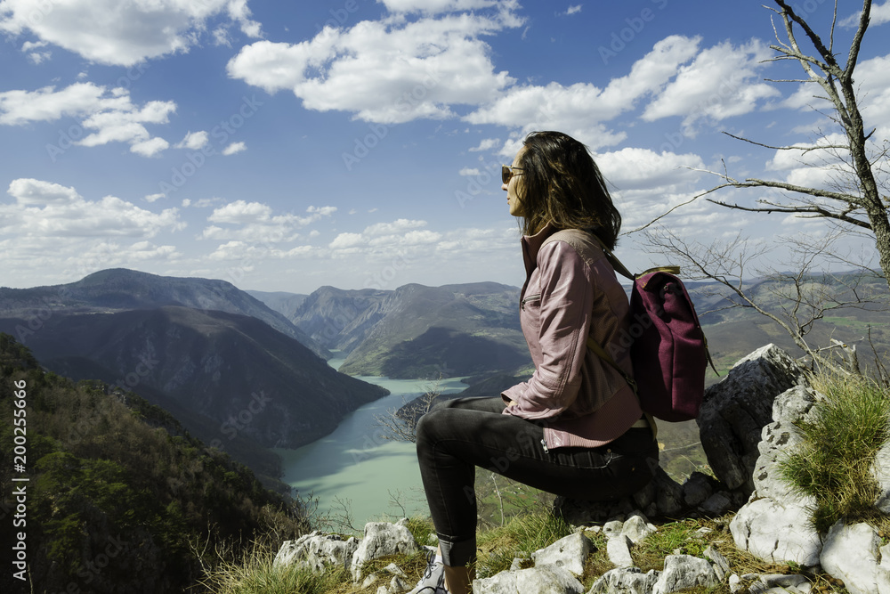Traveler girl relaxing on a beautiful mountain view.
