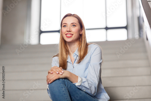 people, business and education concept - happy smiling woman or student sitting on stairs Free Download people, business and education concept - happy smiling woman or student sitting on stairs - GFXLoad
