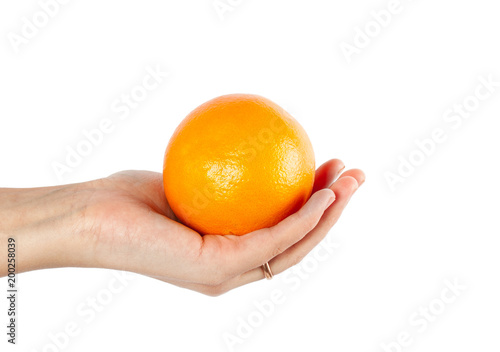 Ripe fresh orange in hand