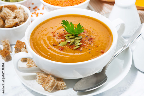 soup of pumpkin and lentils in a bowl, closeup
