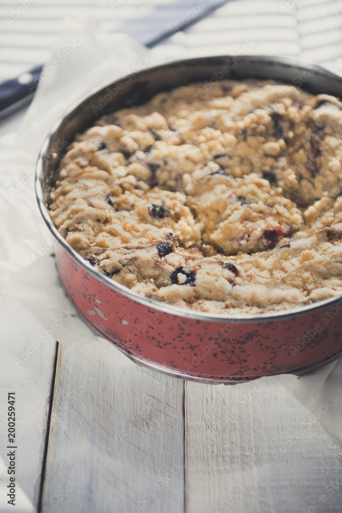 Coffee cake in a tin pan on white wooden table. Vertical. Copy space. Coffee cake in a tin pan on white wooden table. Vertical. Copy space.