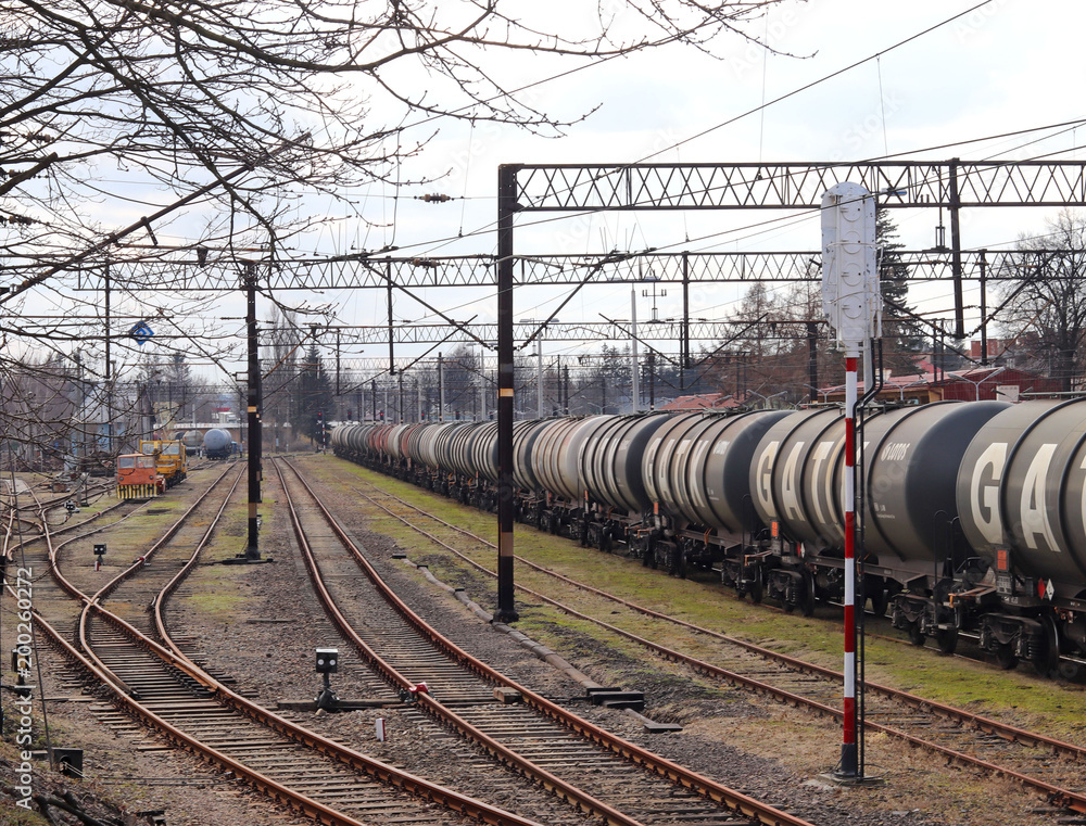 Jaslo/Yaslo, Poland - april 8, 2018: Railway station. Locomotive with an oil tanks wagons. Cargo transportation. Refinery buisnes.  Security at the strategic site. Railroad drive. 