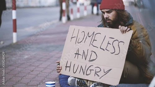 Video of dirty man asking for food and money on the sidewalk because he is hungry and homeless