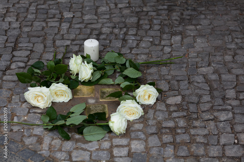 Stolpersteine (stumbling stone) with roses