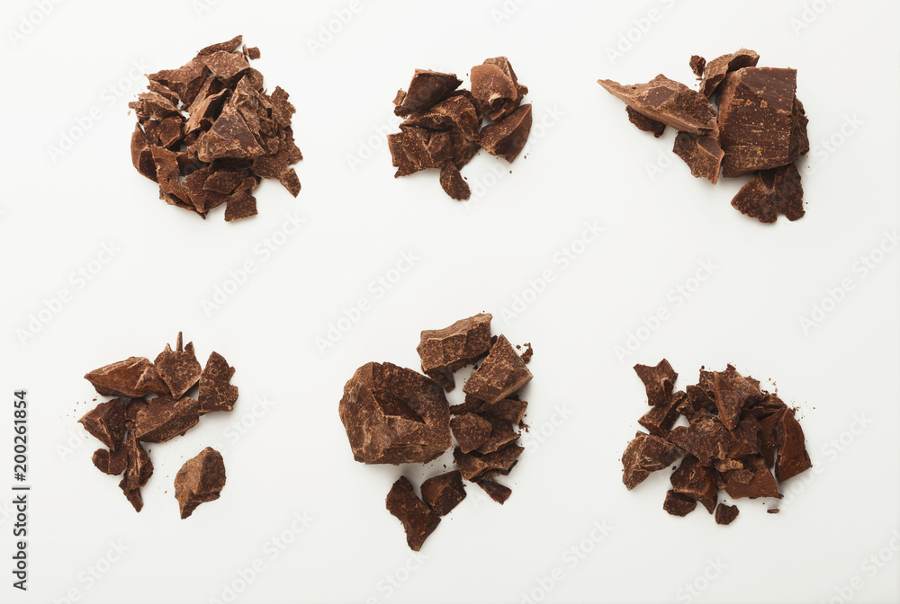 Heap of chocolate pieces isolated on white Heap of chocolate pieces isolated on white
