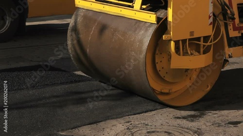 Road roller working on the new road construction site