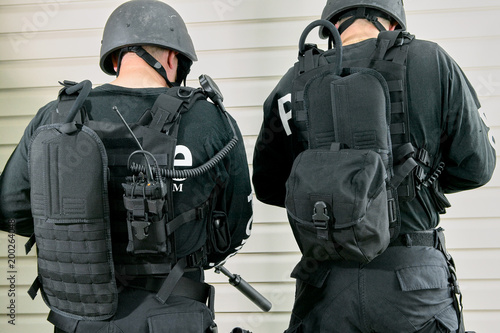 Two police officers wearing different backpacks