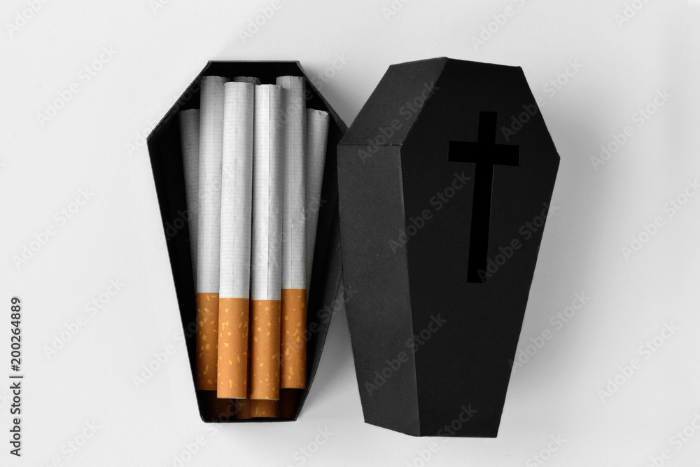 Cigarettes in a black coffin on white background - Stop smoking concept - obrazy, fototapety, plakaty 