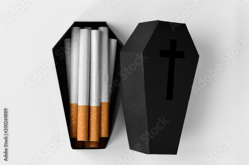 Cigarettes in a black coffin on white background - Stop smoking concept