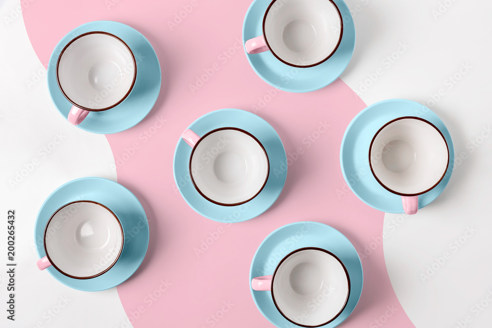 Elegant porcelain blue and pink cups on abstract background Elegant porcelain blue and pink cups on abstract background