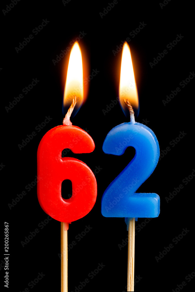Burning candles in the form of 62 sixty two (numbers, dates) for cake isolated on black background. The concept of celebrating a birthday, anniversary, important date, holiday, table setting Burning candles in the form of 62 sixty two (numbers, dates) for cake isolated on black background. The concept of celebrating a birthday, anniversary, important date, holiday, table setting