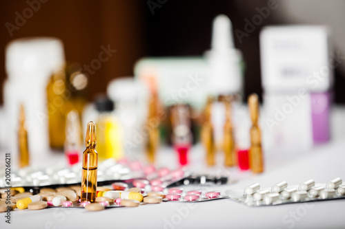 On the table there are ampoules next different pills drugs and medications. With copy space for your text