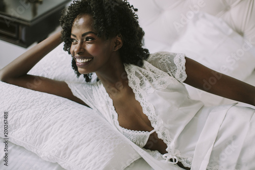 Young black woman in bed