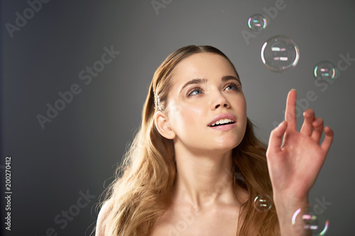 Portrait of young beautiful girl in Studio, with professional makeup. Beauty shooting.Bubble. Atmosphere of lightness, childhood