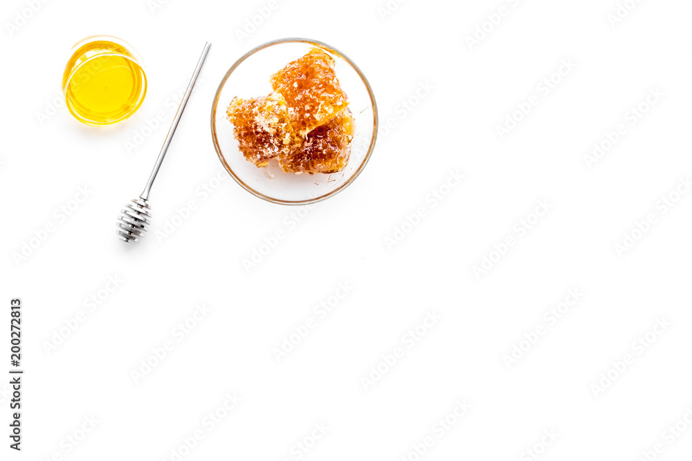 Apiary products. Honey in bowl and honeycomb on white background top view copy space Apiary products. Honey in bowl and honeycomb on white background top view copy space