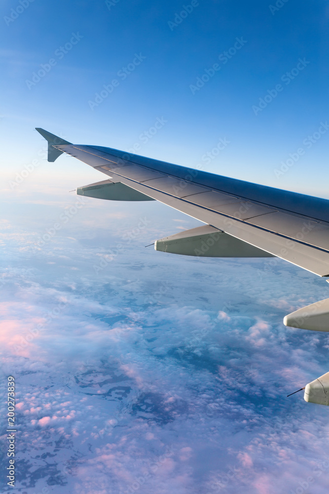 Fototapeta premium Airplane Wing above the Clouds