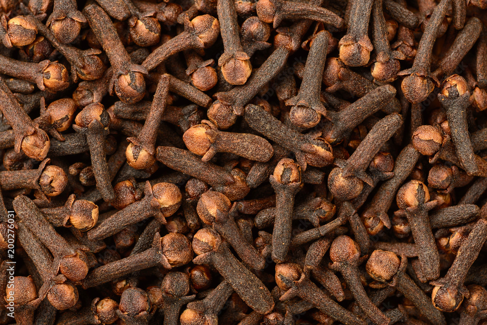 food background of dried cloves, top view