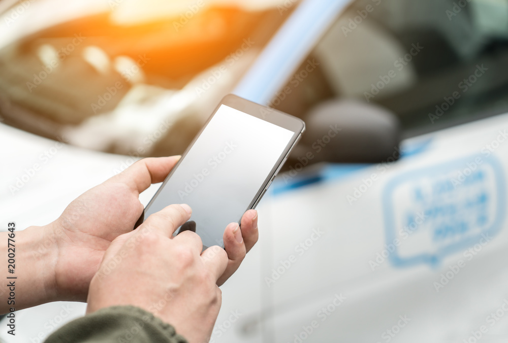 Man calls car with mobile phone APP in parking lot Man calls car with mobile phone APP in parking lot