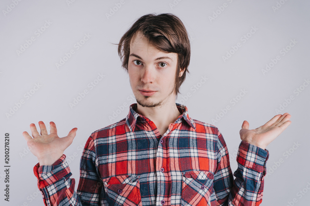 Caucasian man with raised palms on white background, man weighs in hands pros and cons , isolated background - copy space Caucasian man with raised palms on white background, man weighs in hands pros and cons , isolated background - copy space