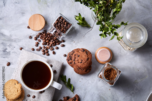 Wallpaper Mural Coffee cup, jar with coffee beans, cookies over white background, selective focus, close-up, top view Torontodigital.ca