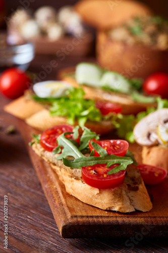 Breakfast sandwich with homemade paste, vegetables and fresh greens, shallow depth of field