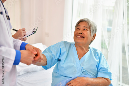 Concept of healing care, The doctor is healing old woman.