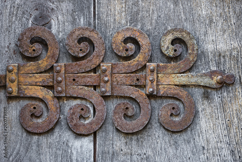 Old ornate rusty door hinge.