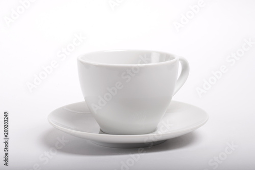Empty ceramic coffee cup with saucer on white background.
