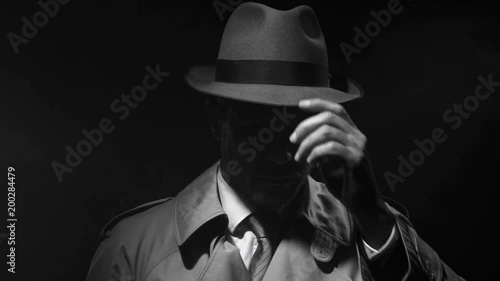 Noir film investigator standing in the dark