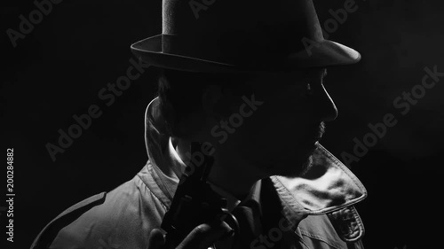 Retro detective spy holding a revolver